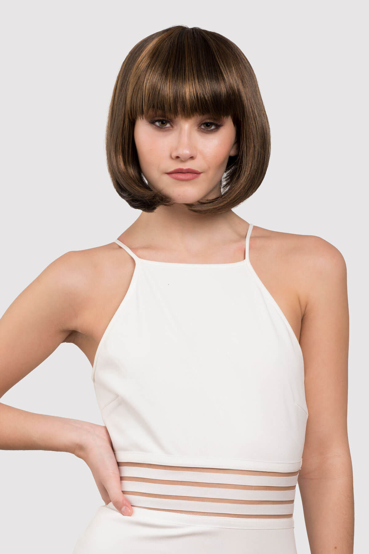 woman wearing a brown wig with blonde highlights. Chocolate brown inverted bob wig with blonde highlights: Keira