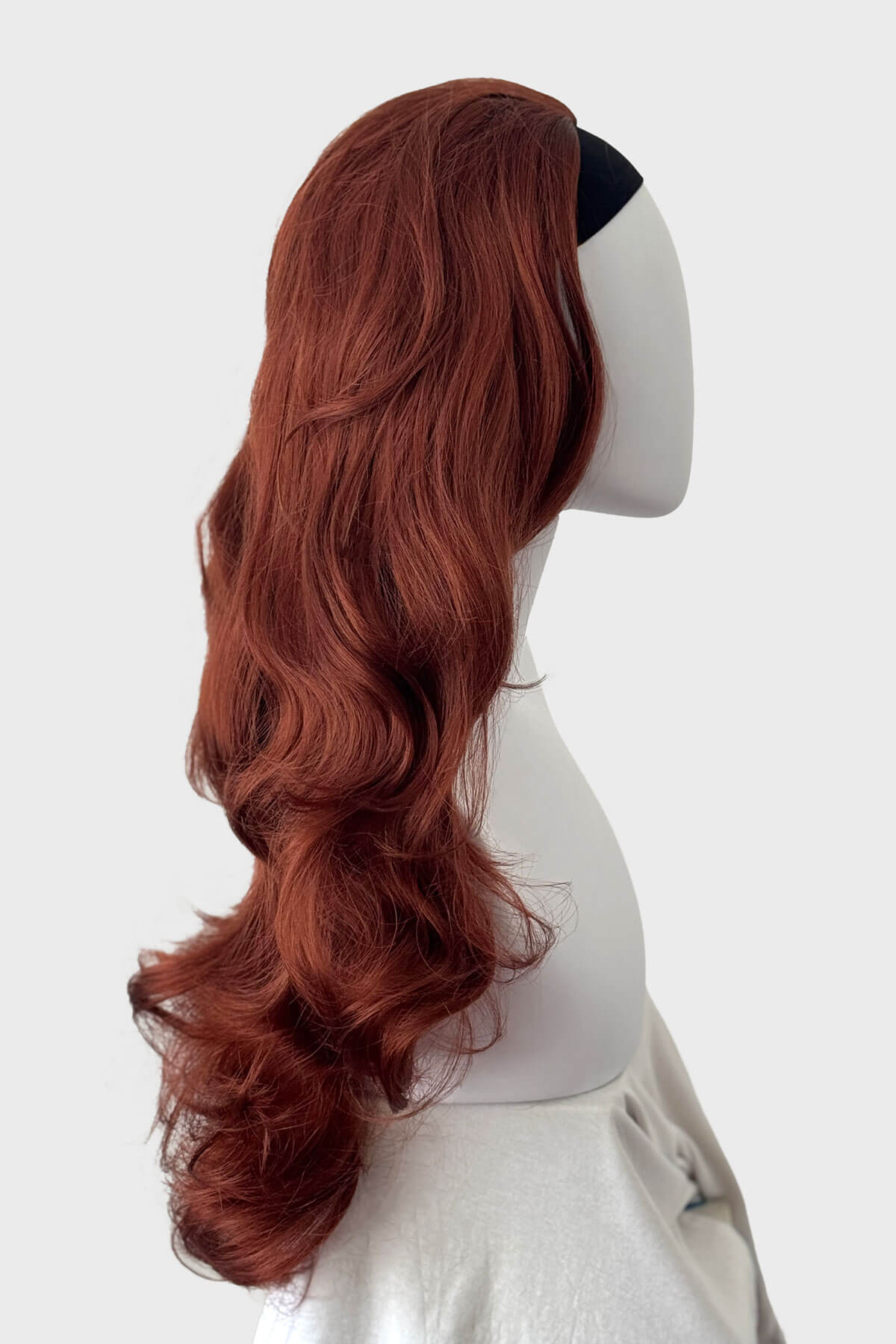 Copper red wig on a mannequin head against a white background. Verity - Super Full Volume, Extra Long Loose Curls Red Half Wig
