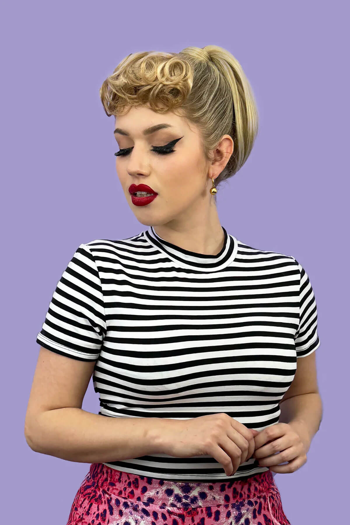 Woman wearing a black and white striped shirt against a purple background. Curly 1940s style clip-in fringe hairpiece/clip-in bangs: Bunny chestnut brown 8