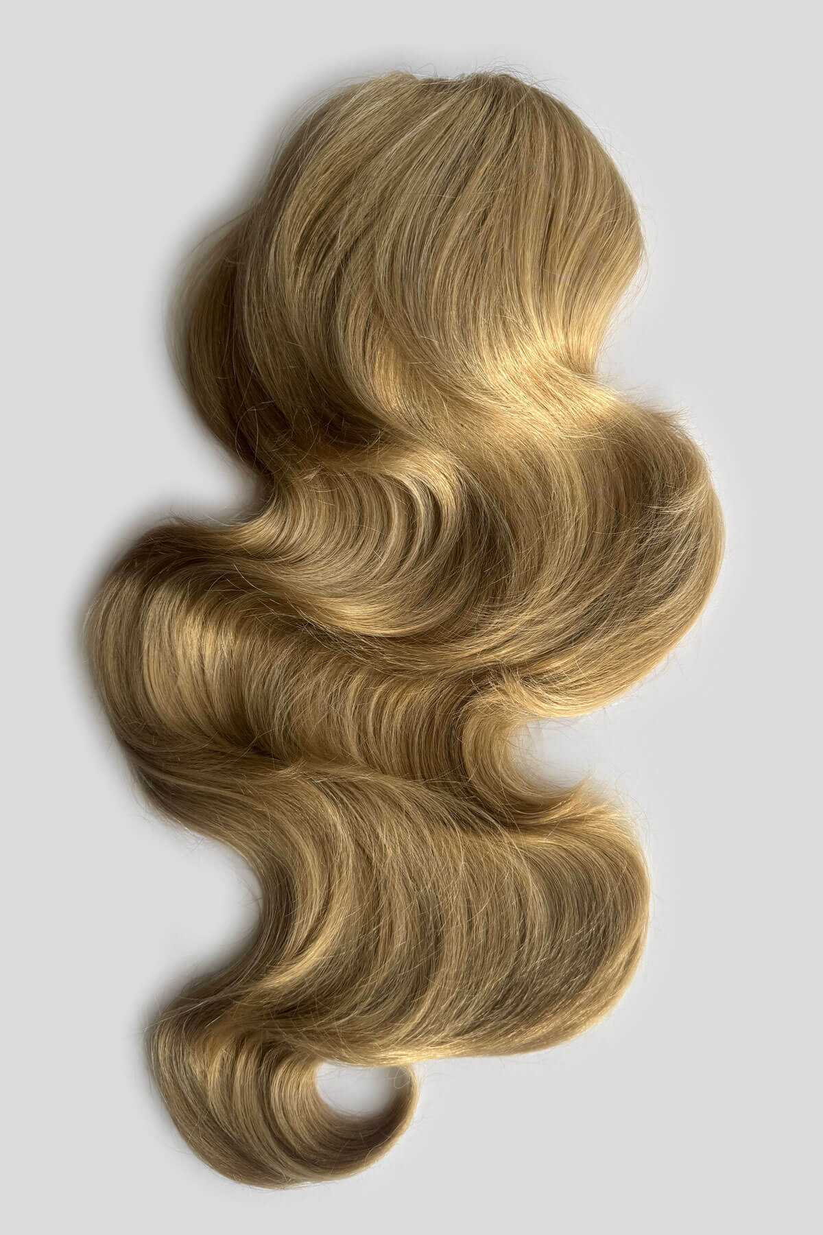 A wavy, shoulder-length blonde hair piece, displayed against a light background. Double volume hairpiece extension: Naomi blonde 24H613