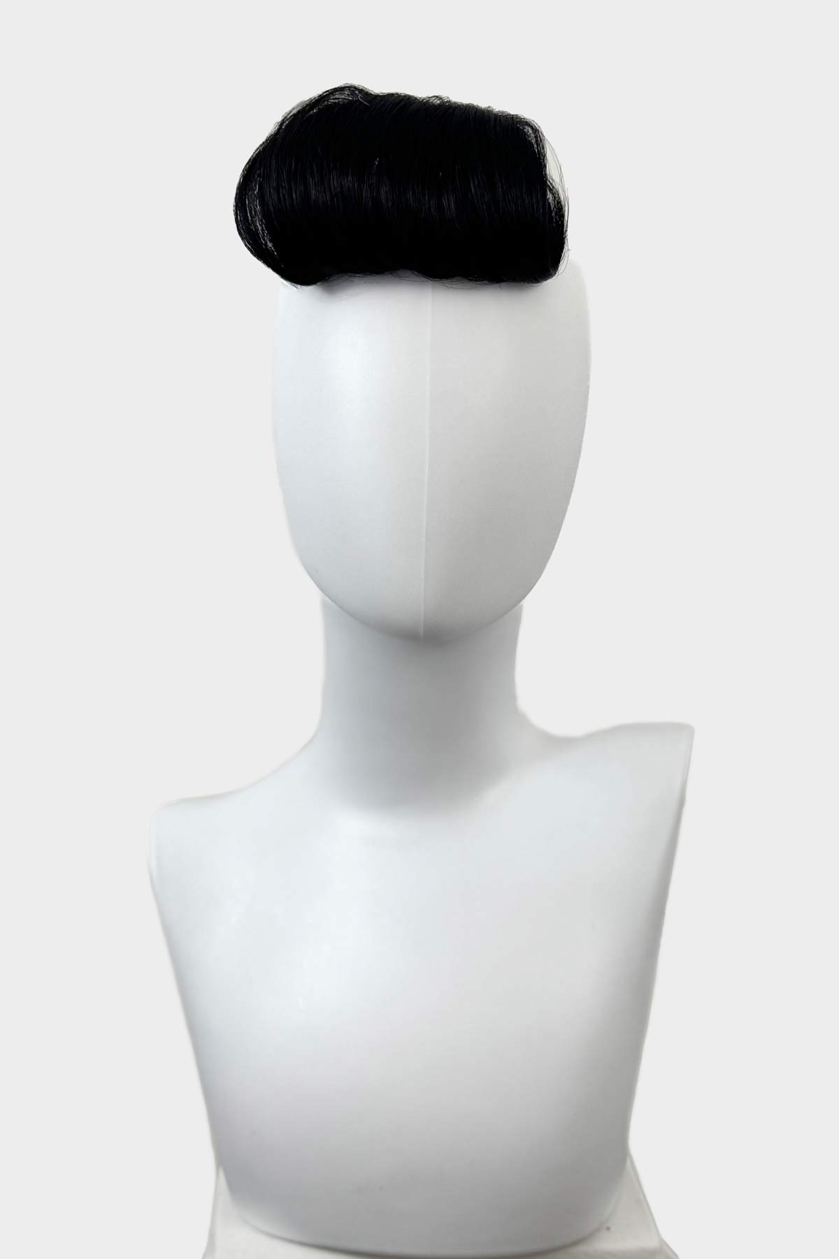 Black hairpiece on a white mannequin head against a white background. Victory roll fringe/bangs, 1950s vintage style: Rosa black 1b