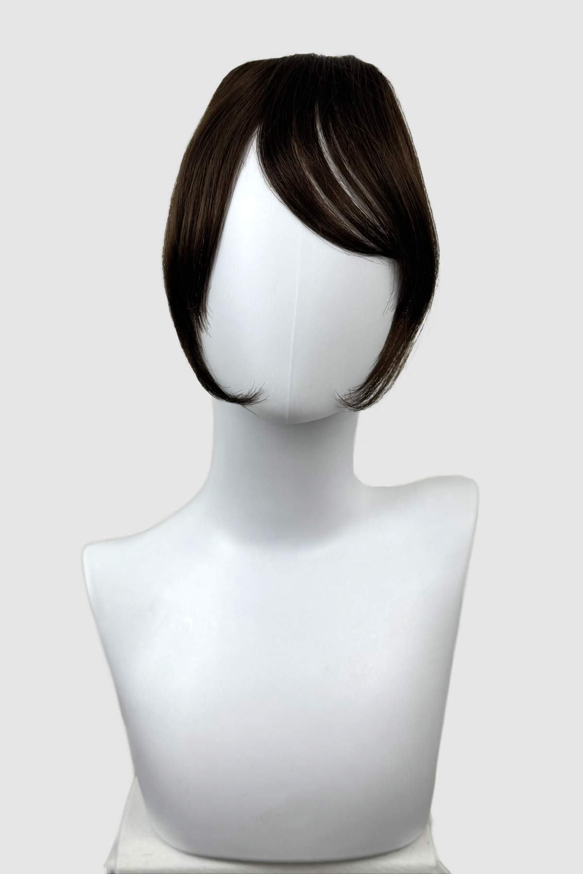 Brown hair clip-in extension on a mannequin head against a white background. Clip in fringe hairpiece/clip-in curtain bangs, with long, face framing wisps: Sabrina chestnut brown 8