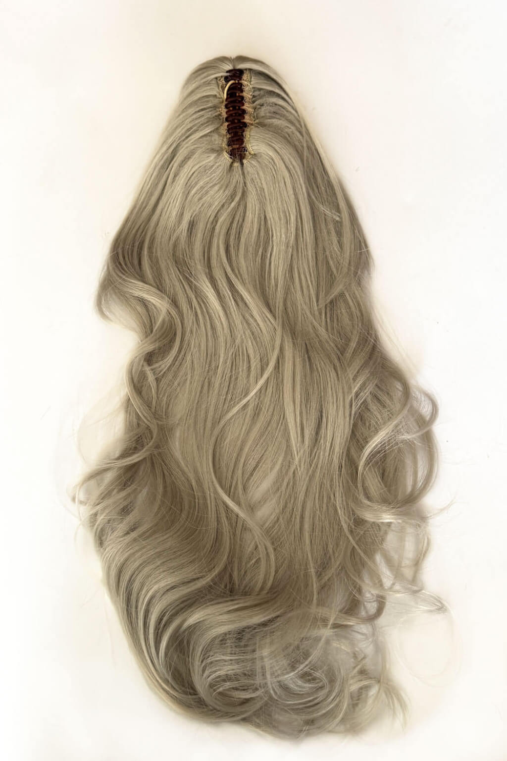 A long, wavy synthetic ponytail wig,  against a plain off-white background. Clip-in ponytail hairpiece extension: Olivia silver 60