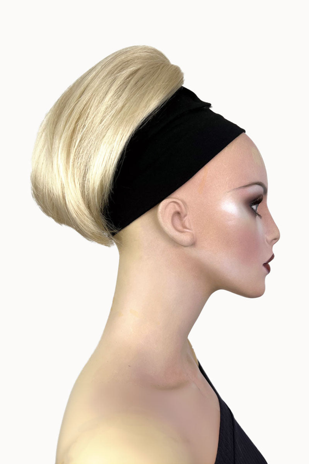 A woman wearing a white halter neck top showcasing a short ponytail extension hairpiece in a straight, full, and bouncy style. Short ponytail extension hairpiece, straight, full & bouncy: Tanaya blonde 613