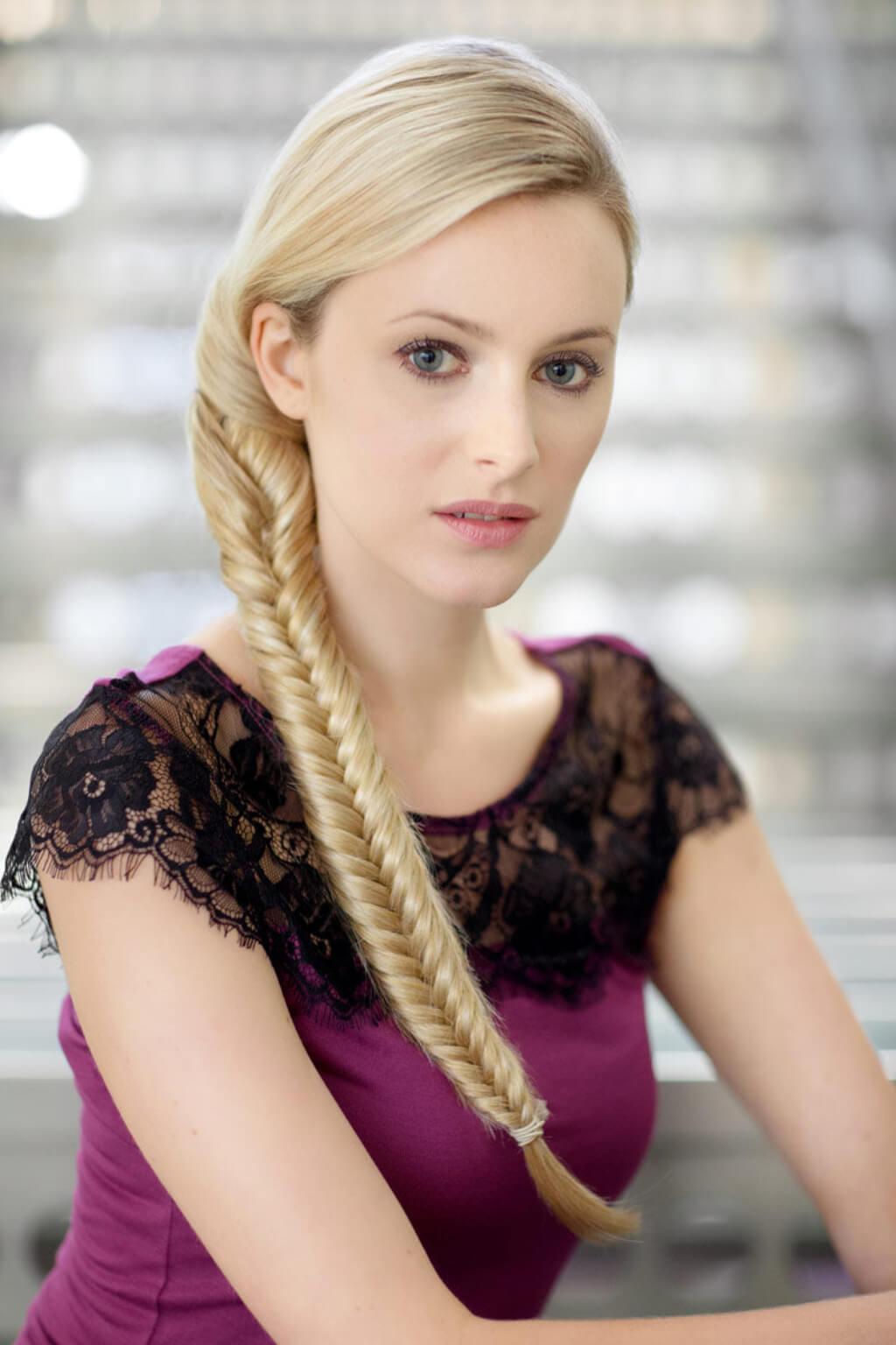 A woman wearing a white top showcasing a fishtail plait hairpiece extension. Fishtail plait (braid) hairpiece extension: Tinsley