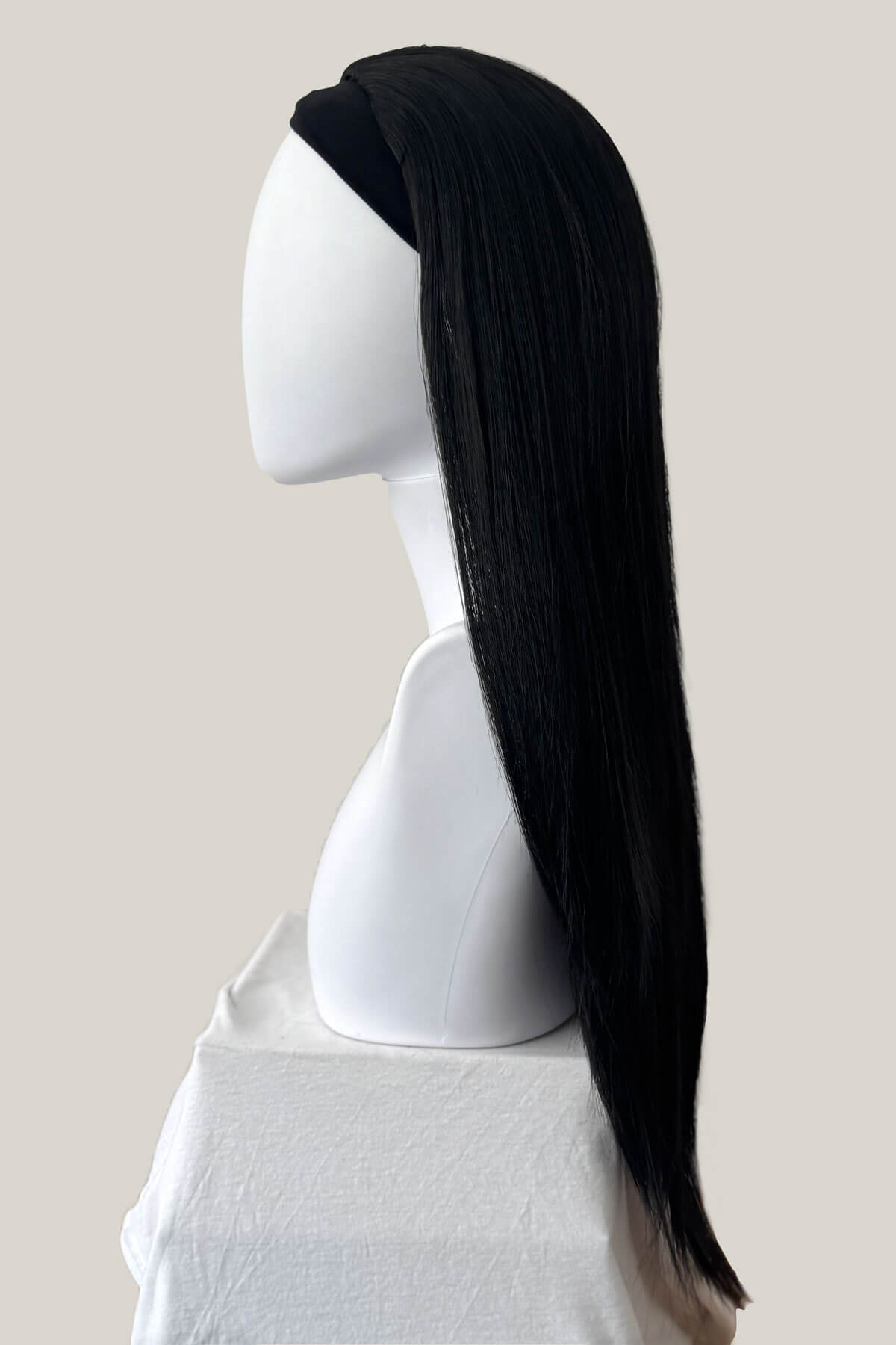 Black wig on a white mannequin head against a plain background. Straight black half wig hairpiece extension (3/4 wig): Theda black 1B