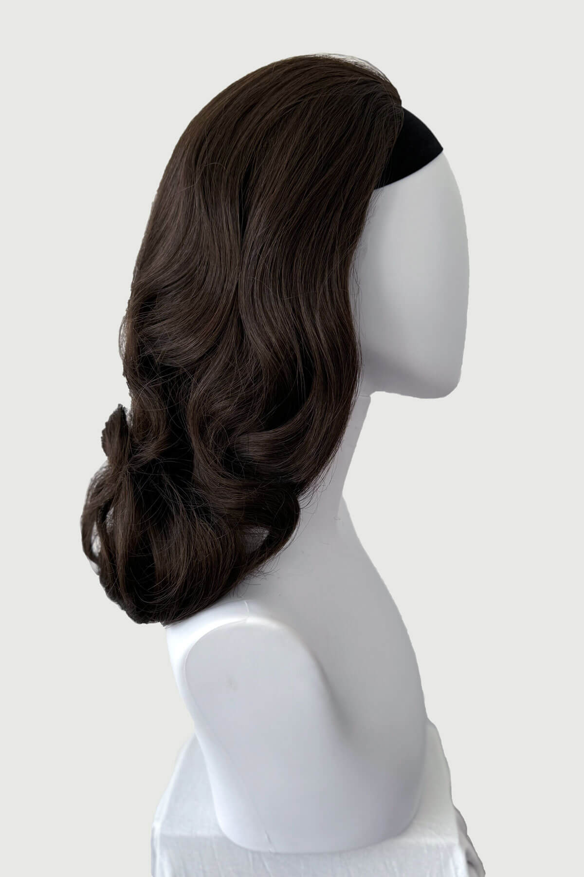 Mannequin head with long brown wig on a white background shown from the side. 1950s style shoulder length half wig hairpiece with beautiful vintage waves: Onyx chestnut brown 8 