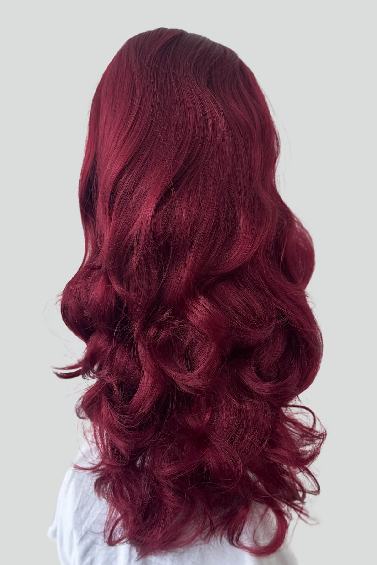 Long, wavy red hair on a white background. High crown long, wavy half wig and volume ring, cherry red: Bardot 39