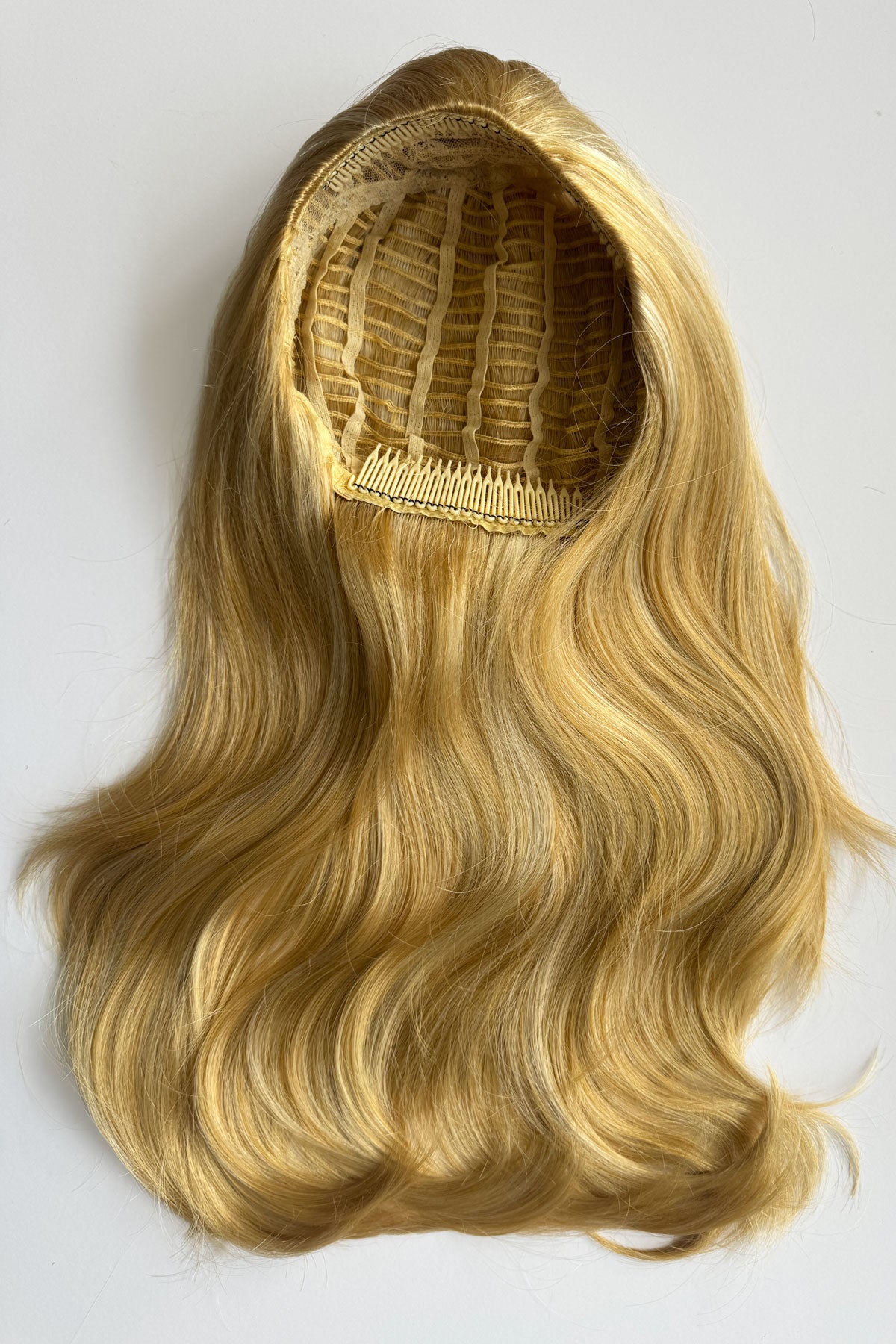 A long wavy blonde half wig, photographed against a plain light background. Claudia - Volume Boosting Long Gentle Bouncy Layered Half wig honey blonde 24BH613