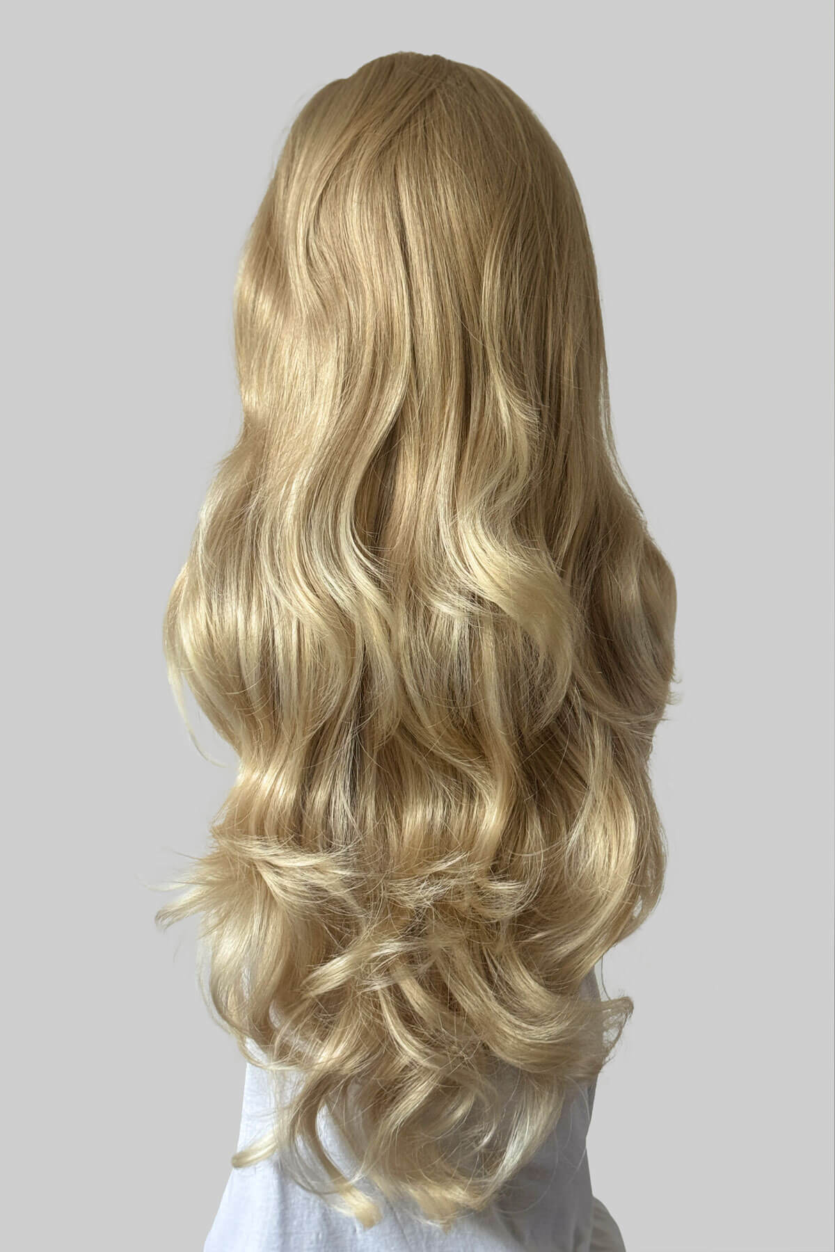 Long wavy blonde half wig with loose curls, shown from the back on a mannequin against a solid grey background. Corrine - Bouncy Blowout style with Volume Booster Half Wig blonde 613T24