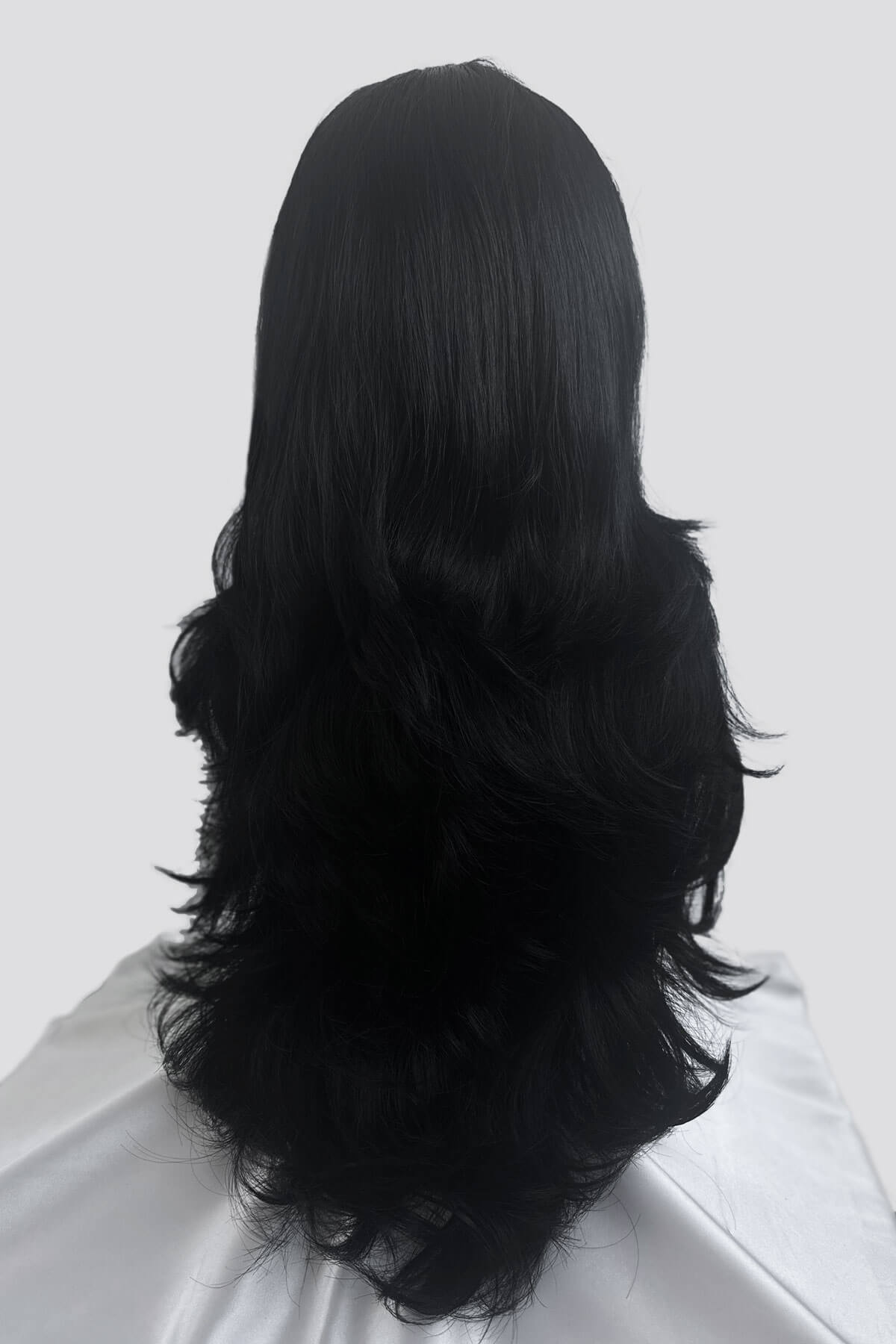 Black wig on a white background. Black half wig hairpiece (3/4 wig), long layers: Aislynn jet black #1