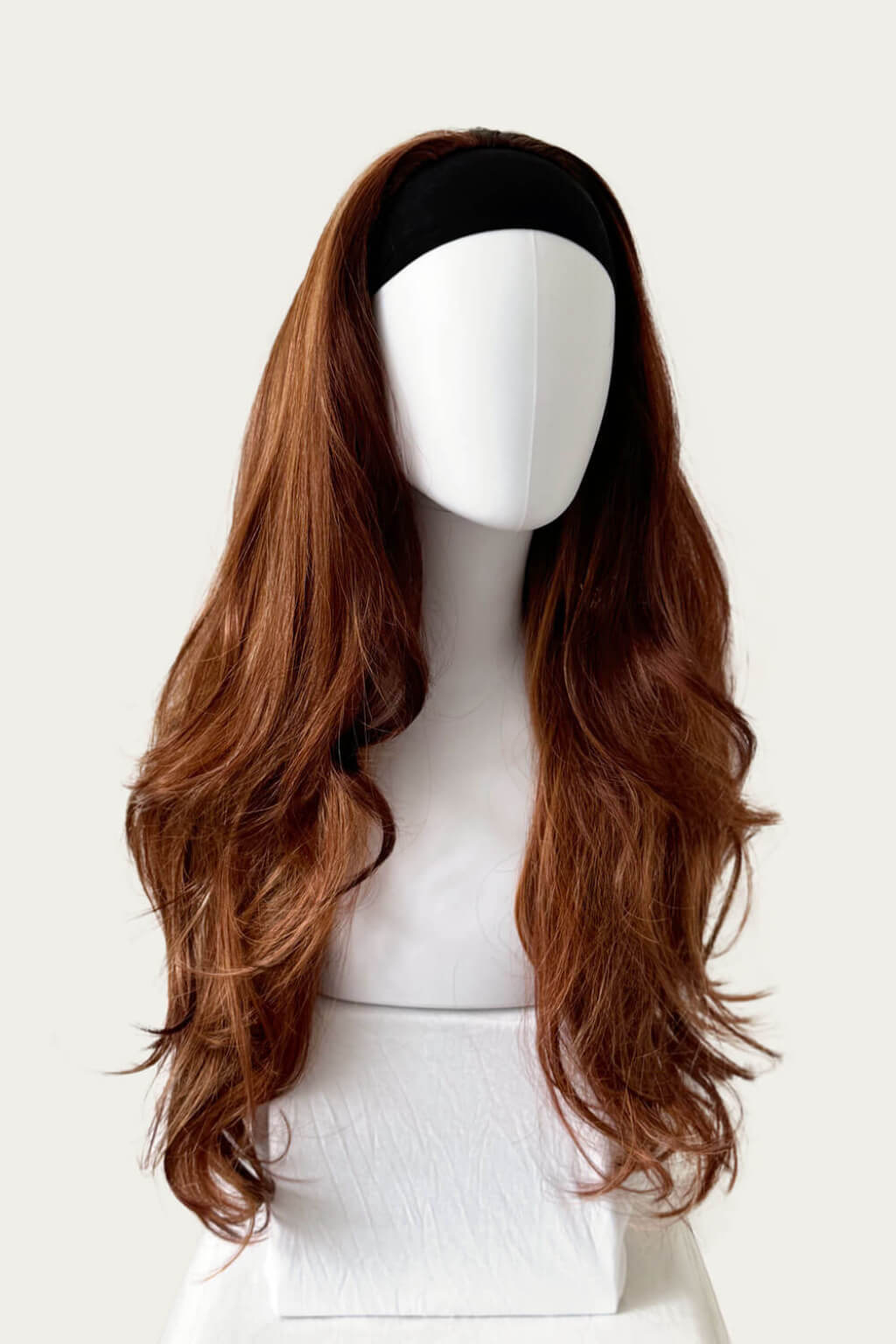 Brown wig on a mannequin head against a white background. High crown long, wavy half wig and volume ring: Bardot Auburn blonde BO
