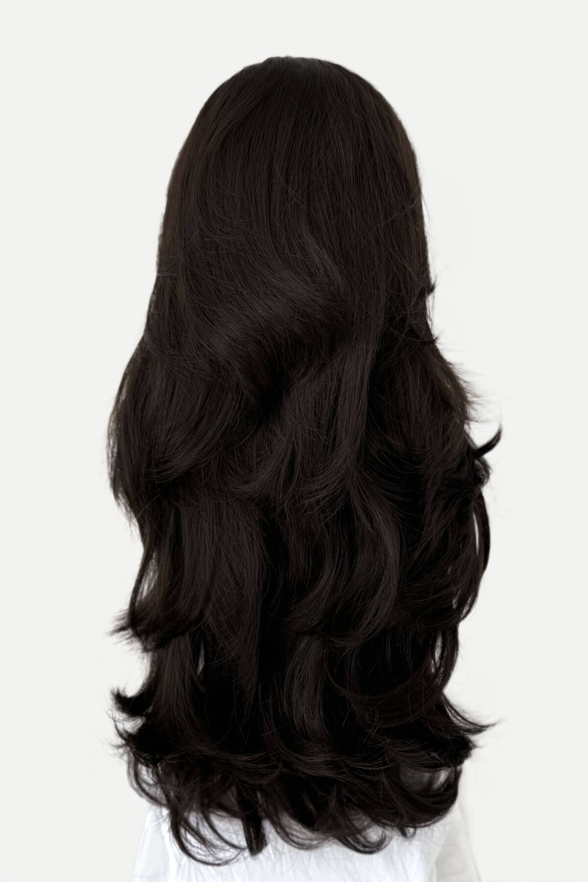 Black wig with wavy hair on a white background.  Brown half wig hairpiece (3/4 wig), layered, wavy: Simone dark brown 6