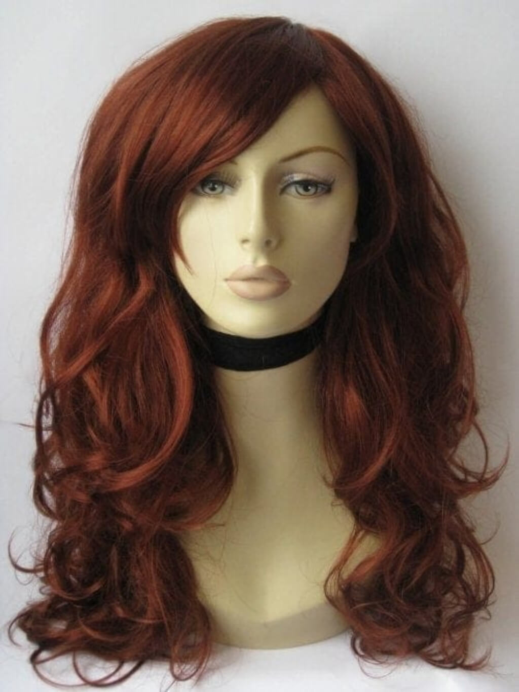 Red wig on a mannequin head against a white background. Long, copper red wig: Marcia