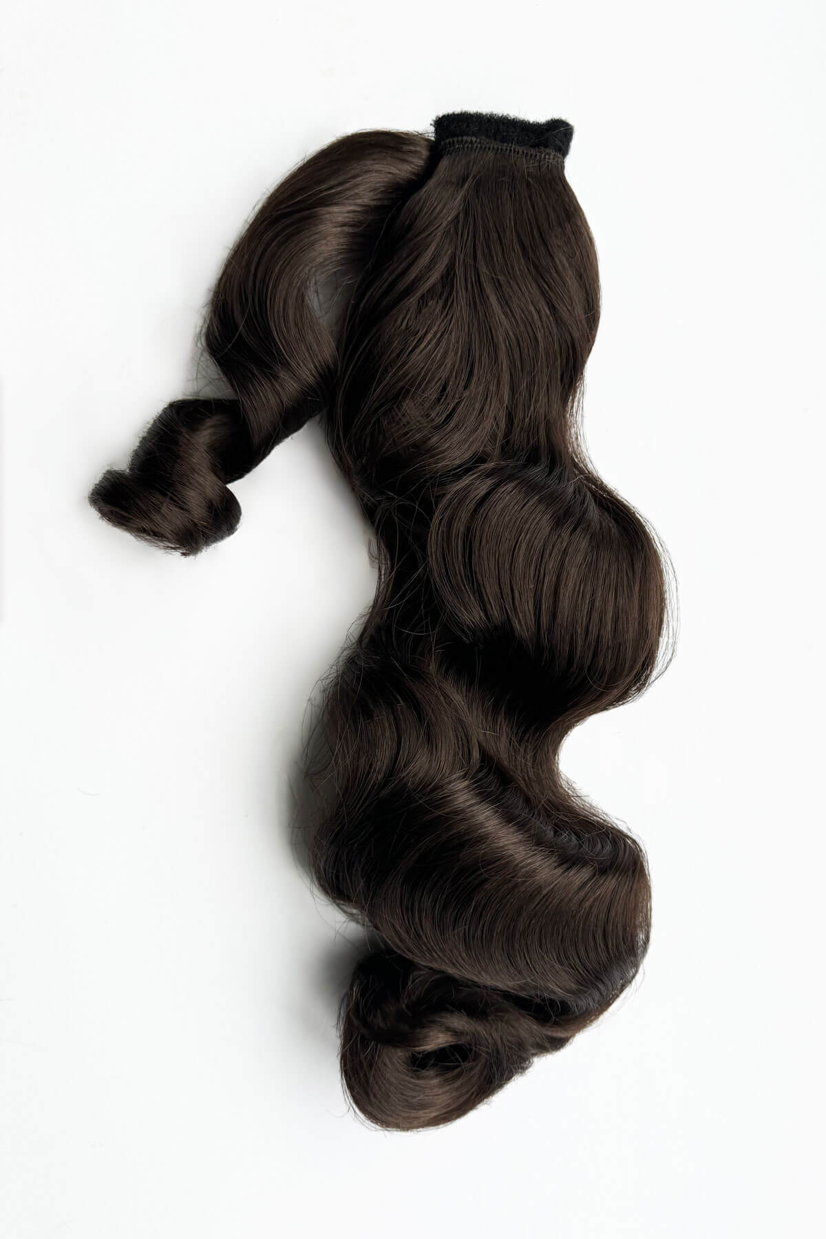 Brown hair extensions on a white background. Retro style ponytail hairpiece, long with vintage waves: Arabella