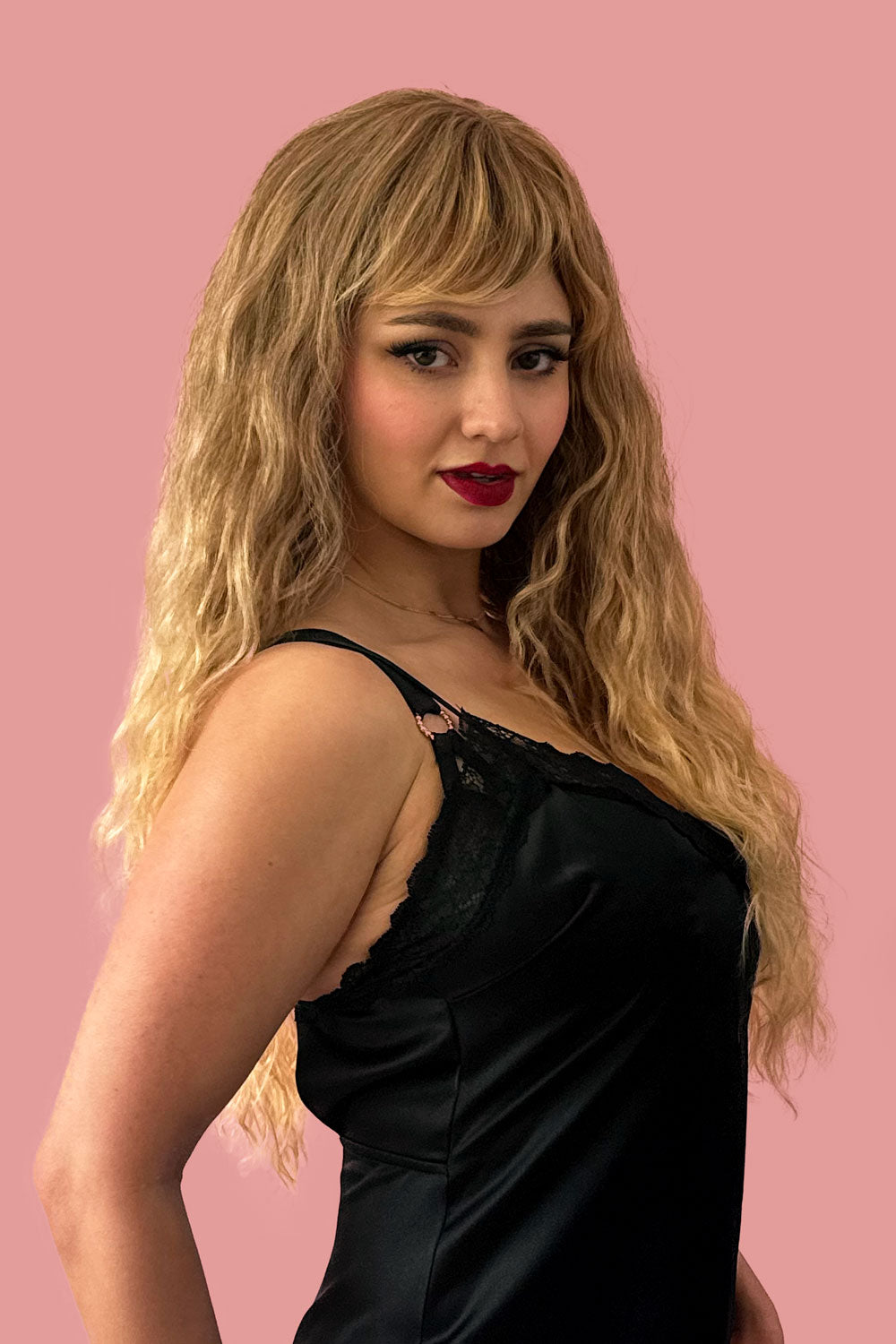A person wearing a long brown crimped wig with brown and blonde ombre dip dye. Long brown crimped wig, brown and blonde dip dye (ombre): Tiggy
