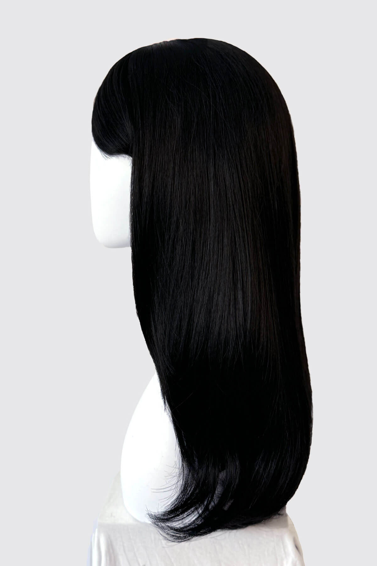 Straight black wig on a mannequin. Long black wig, face frame style with full, sweeping fringe: Corina