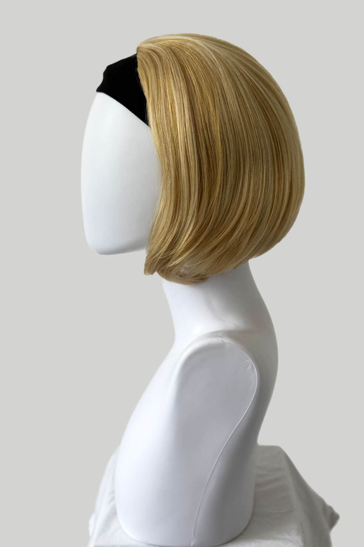Blonde wig on a mannequin head against a plain background.  Bob half wig hairpiece, Flexihair: Amelie honey blonde 24BH613