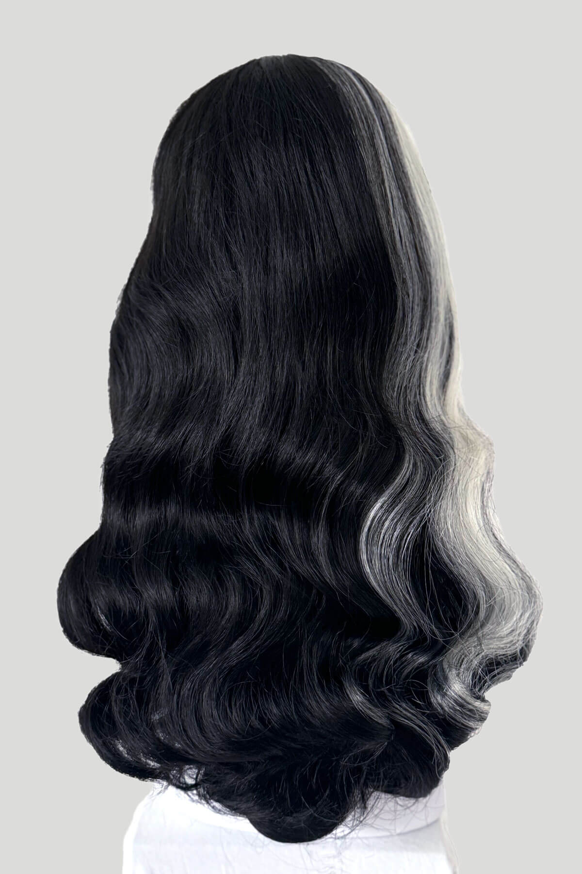 Black and gray ombre wig on a white background. Long black 1950s pin up style wig with platinum streak and retro fringe: Michelle